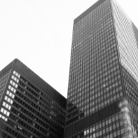 B&W photo looking up at two office buildings